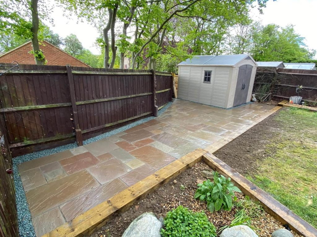Stone patio with shed