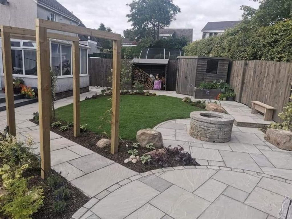 Pergolas, stone patio and lawn